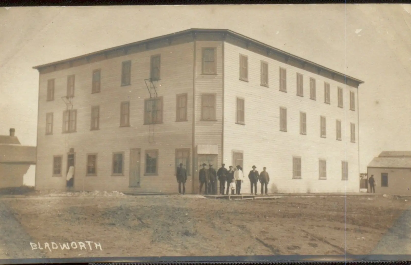 Large three-storey building with townsmen, Bladworth